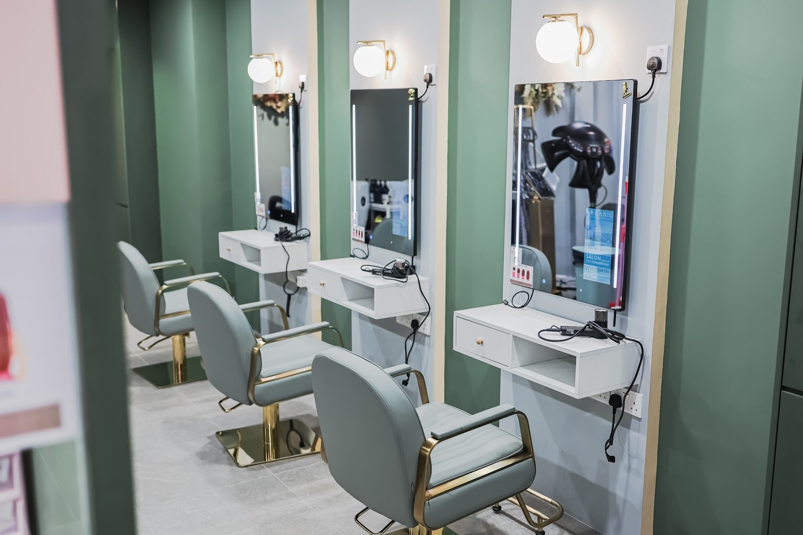 Styling stations with green walls and round mirrors